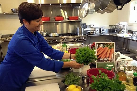 Chef-teacher Carolyn Grieco preparing the work stations for the hands-on workshop